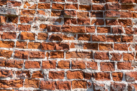 Background, texture of an old wall of crushed red brick