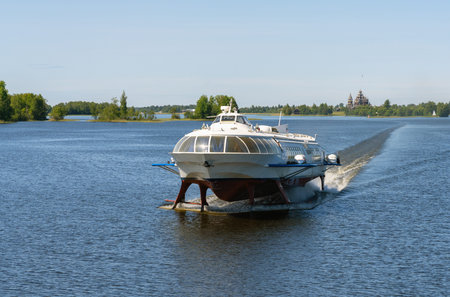 Tourist motor ship Meteor hydrofoils floating on Lake Onega against the background of the Kizhi...