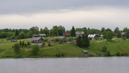 Life of the Russian North, old dilapidated houses along the coast of the Svir Riverの写真素材