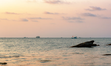 Fishing boats in the South Sea on the background of sunsetの写真素材