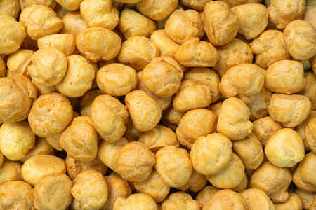 The background is a texture of a large number of profiteroles lying on top of each otherの写真素材