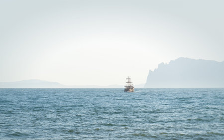 Vintage sailing ship sailing on the sea near the coast