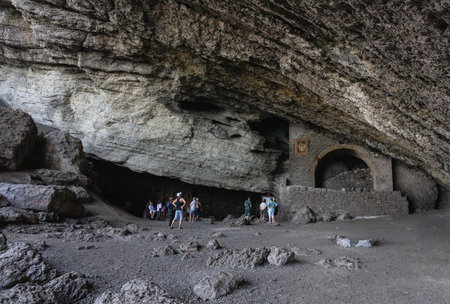 Tourists exploring the grotto on the Golitsyn Trail in the village of Novy Svet