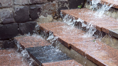 Flood in the city. Water drains from the steps. Close upの写真素材