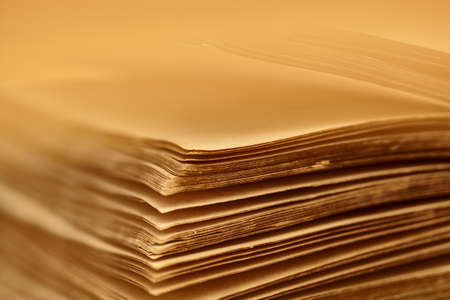 Abstract blurred background of sheets of an old book. Macro view of pages of a book. Yellowed sheets of old paper. Copy space for text. Book open pagesの写真素材