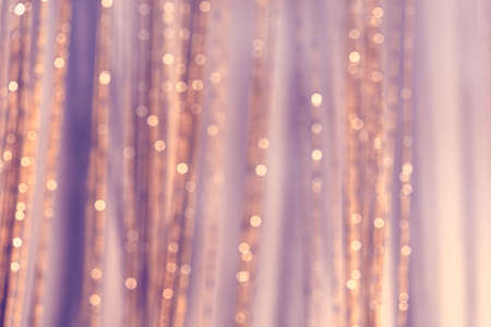 Blurred background with purple accent.Beautiful gentle soft background. Minimalism. Mysterious Christmas defocused background. Festive frame with twinkling bokeh stars. Abstract blurred bokeh curtain.の写真素材