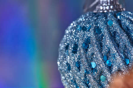 Christmas abstract beautiful background. Halogram effect. Blurred tender background with Christmas toy. Close-up Christmas ball in glitter. Christmas background with free space for your text, design.の写真素材