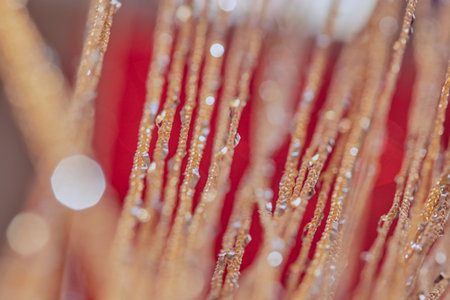 Red-yellow blurred background with bokeh. Beautiful gentle soft background. Mysterious Christmas defocused background. Festive frame with twinkling bokeh stars. Background for greeting cards, text.の写真素材