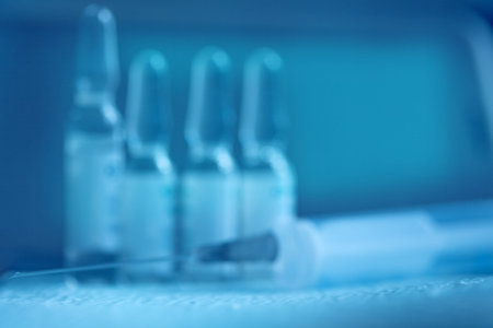 Blurry medical blue background. Syringe and medicine. Syringe and ampoules medical concept.