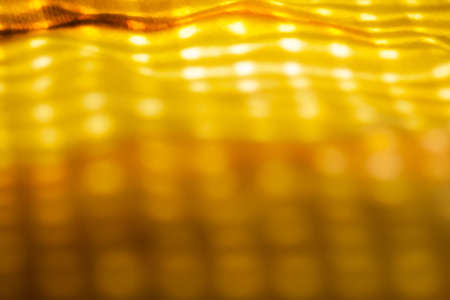 Full bokeh blur background filled with light. Abstract blurred background with yellow accent.の写真素材
