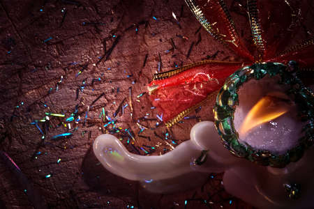 Abstract Christmas composition. Background with a burning candle with free space for your text.Flyer, party invitationの写真素材