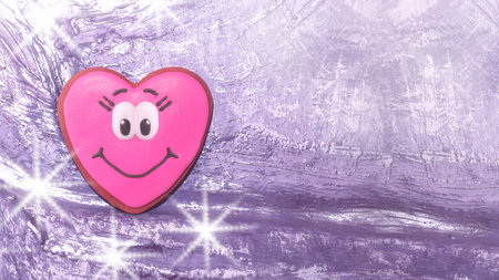 .Pink Heart Purple Background Grunge Texture.Pink gingerbread heart for Valentine's Day.