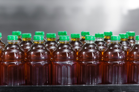 bottles of juice on a production lineの写真素材