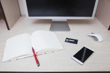 Computer monitor notebook pen smartphone credit card digital wireless mouse. Online shopping concept. Organized working spaceの写真素材