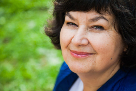 Beautiful middle aged woman closeup portrait. Smiling lady