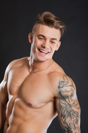 Handsome guy with sporty fit body smile show six pack absの写真素材