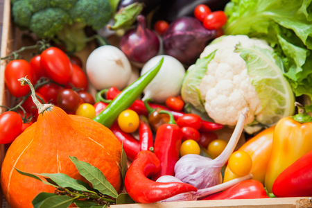 Fresh autumn vegetables in wooden box organic food concept. harvest raw eating healthy diet background copy space top view closeupの写真素材