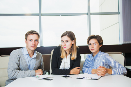 Three young business people look confident ready for success. Teamwork brainstorming conceptの写真素材
