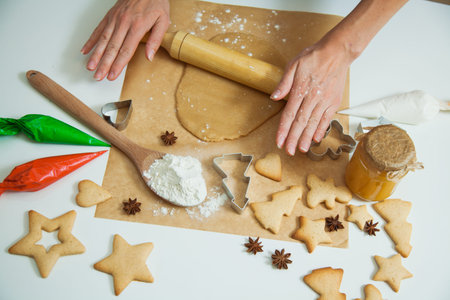 Cooking Christmas gingerbread cookies decorating for new year celebration. Female hands with...