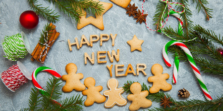 Christmas new year background greeting card gingerbread candy fir tree cones cinnamon holiday conceptの写真素材