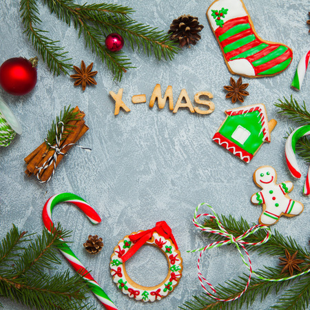 Christmas new year background greeting card gingerbread candy fir tree cones cinnamon holiday conceptの写真素材