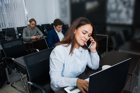 Working process, female office worker talk by telephone with colleagues. Teamwork, brainstorming, business situation conceptの写真素材