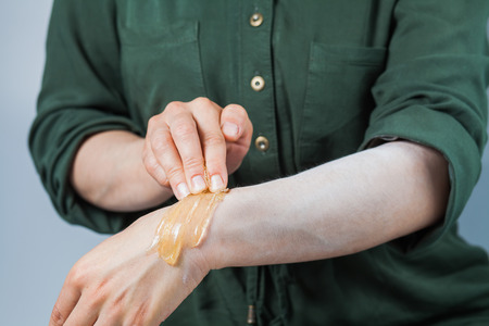 Tutorial hair removing sugaring, depilation, waxing. Closeup female hands using sugar paste. Beauty skin conceptの写真素材