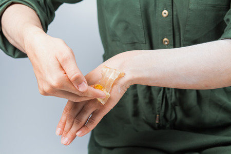 Tutorial hair removing sugaring, depilation, waxing. Closeup female hands using sugar paste. Beauty skin conceptの写真素材
