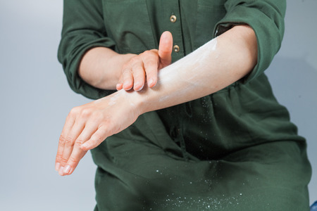 Tutorial hair removing sugaring, depilation, waxing. Closeup female hands using dusting powderの写真素材