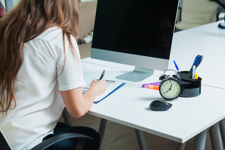 Unrecognizable woman work hard at office table with computer. Business secretary make documents. Office life conceptの写真素材