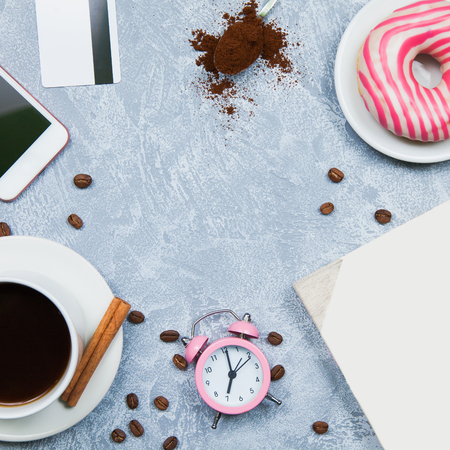 Background of coffee smartphone nuggets credit card, notebook, alarm clock. Freelancer conceptの写真素材