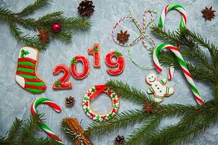 Christmas new year background greeting card gingerbread candy fir tree cones cinnamon holiday conceptの写真素材