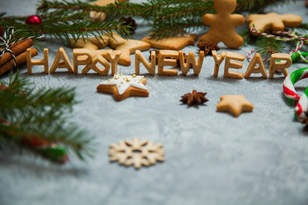 Christmas new year background greeting card gingerbread candy fir tree cones cinnamon holiday conceptの写真素材