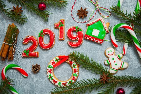 Christmas new year background greeting card gingerbread candy fir tree cones cinnamon holiday conceptの写真素材