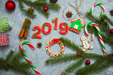 Christmas new year background greeting card gingerbread candy fir tree cones cinnamon holiday conceptの写真素材