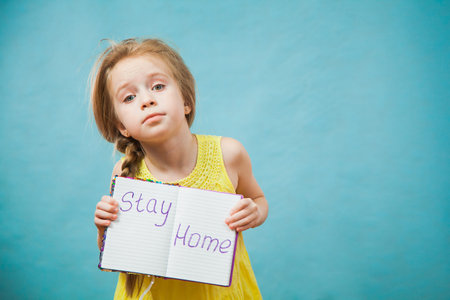 Preteen little girl in antiviral medical mask with massage stay home. Social distance, quarantine...