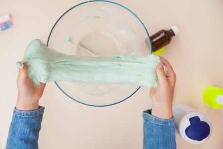 Making slime, step by step instruction, final step seven the toy is ready. Child's hands preparing homemade toy.の写真素材