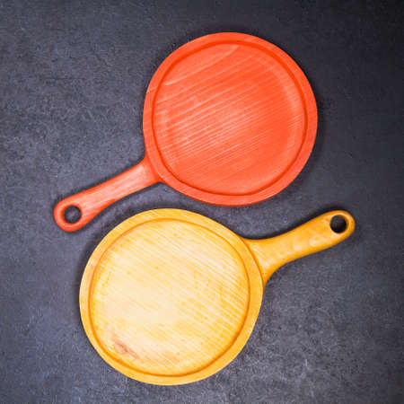 wooden rustic handmade serving boards on dark table. Top view flat layの写真素材