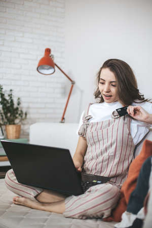 Young millennial woman shopping online at home.の写真素材