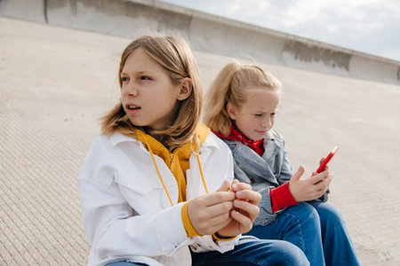 Preteen friends boy and girl play smartphone gadget.