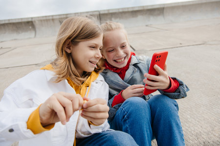Preteen friends boy and girl play smartphone gadget.の写真素材