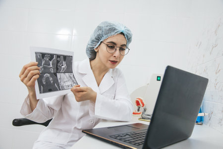 Young female doctor consulting patient via internet using laptop. Telemedicine, medical technologies, video call.の写真素材
