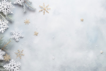 Top view of Christmas snowflakes, and fir tree branches arranged on a on gray pastel background, with ample copy space for your holiday message or design.の素材