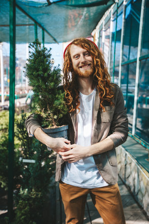Dedicated gardener lovingly tends to plants in a bright and warm space, demonstrating a deep connection to natureの写真素材