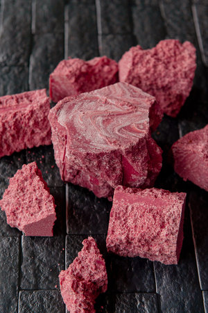 Turkish delight on black background. Selective focus. Shallow depth of field.