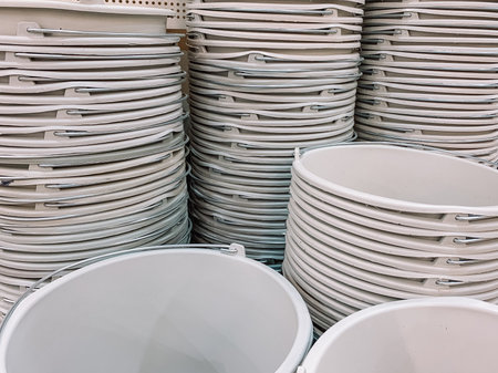 stacks of beige plastic bucketsの写真素材