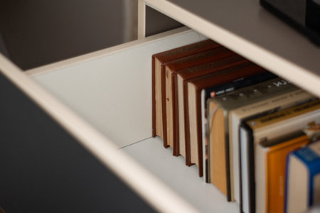 Books are stacked in the chest of drawersの写真素材