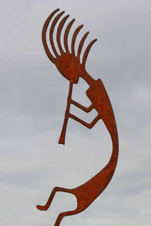 Kokopelli silhouette against a cloudy skyの写真素材