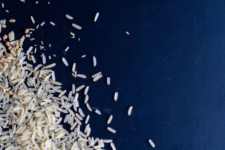 Scattered rice and spices on a darkの写真素材