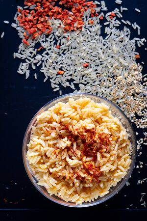 rice with spices on a dark background, saffronの写真素材